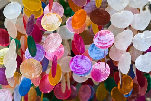 An art mobile hangs and moves in the wind